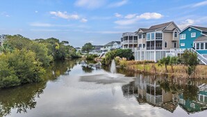 A canal with houses on one side and dense greenery on the other. - The FAMILY Spot in Wild Dunes - Walking Distance to Beach - Pool Access (Isle Of Palms)