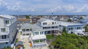 A coastal residential area with multiple two-story houses featuring balconies and large windows.