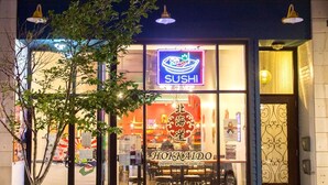 A building with arched windows and a neon sign for a sushi restaurant. - Artistic Loft close to Lake Michigan beaches, craft breweries & outlet shopping (Michigan City)