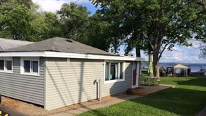 A single-story mobile home with a small porch, a window, and a door.