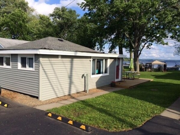 A single-story mobile home with a small porch, a window, and a door.