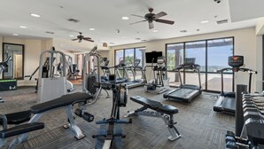 A gym with various exercise equipment, large windows, and ceiling fans. - Top Rental at SEACHASE!!! Totally remodeled!!! (Orange Beach)
