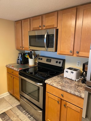 Enjoy cooking in this well-equipped kitchen with a microwave, toaster, coffee maker, and oven.