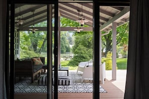 Relax in a serene outdoor oasis with a patio view, comfortable seating, and a wooden deck.