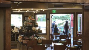 L’intérieur du café Deer Valley Grocery, avec son mobilier en bois et un panneau indiquant la sortie, est bien visible.