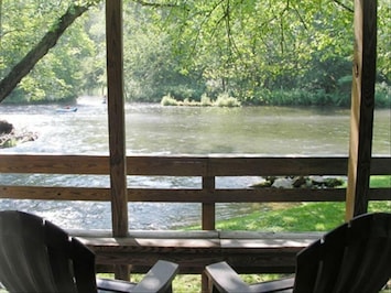 Relax on the covered deck and enjoy the rushing sounds of the river