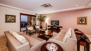 A modern living room with a sofa set, a coffee table, and a television.