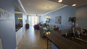 A modern kitchen with a dining area, large windows, and a ceiling fan. - Relaxin' at The Pearl.
Ocean front condo with direct beach access. (Navarre)
