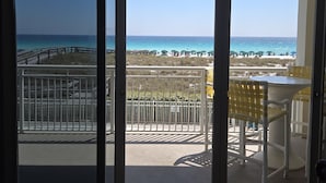 A balcony with a view of the beach, a table, and chairs. - Relaxin' at The Pearl.
Ocean front condo with direct beach access. (Navarre)