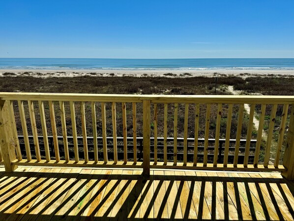 A wooden deck with a view of the beach and ocean. - Beachfront/Gulf Front Property/Dog Friendly (Galveston)