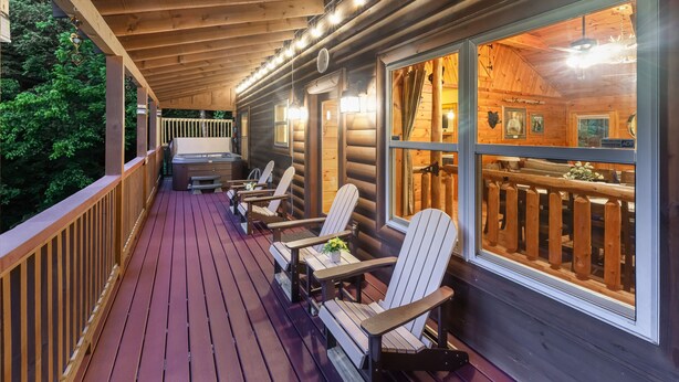 A wooden deck with Adirondack chairs and a covered area with windows. - Amazing & beautiful with huge yard for kids to play with outdoor games, fire pit (Sevierville)