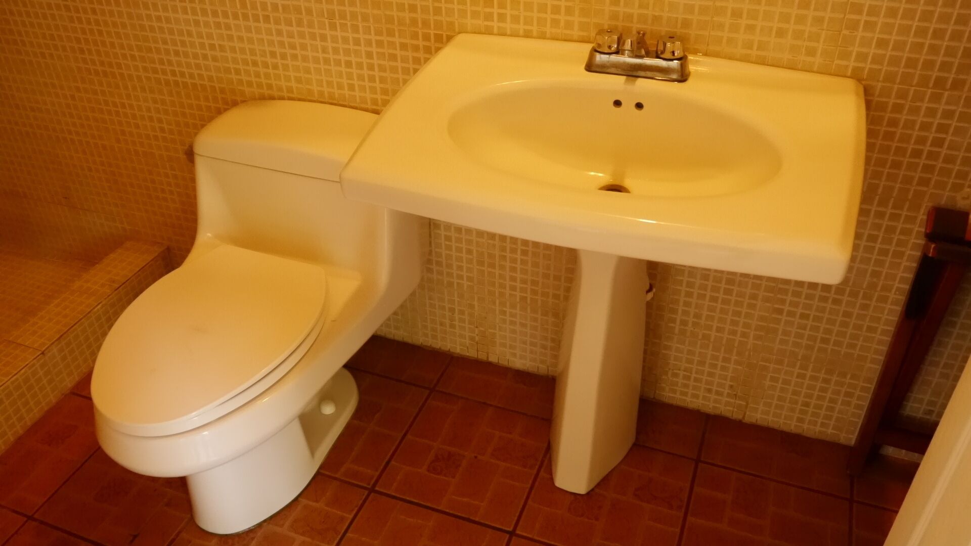 A bathroom with a toilet and a sink.