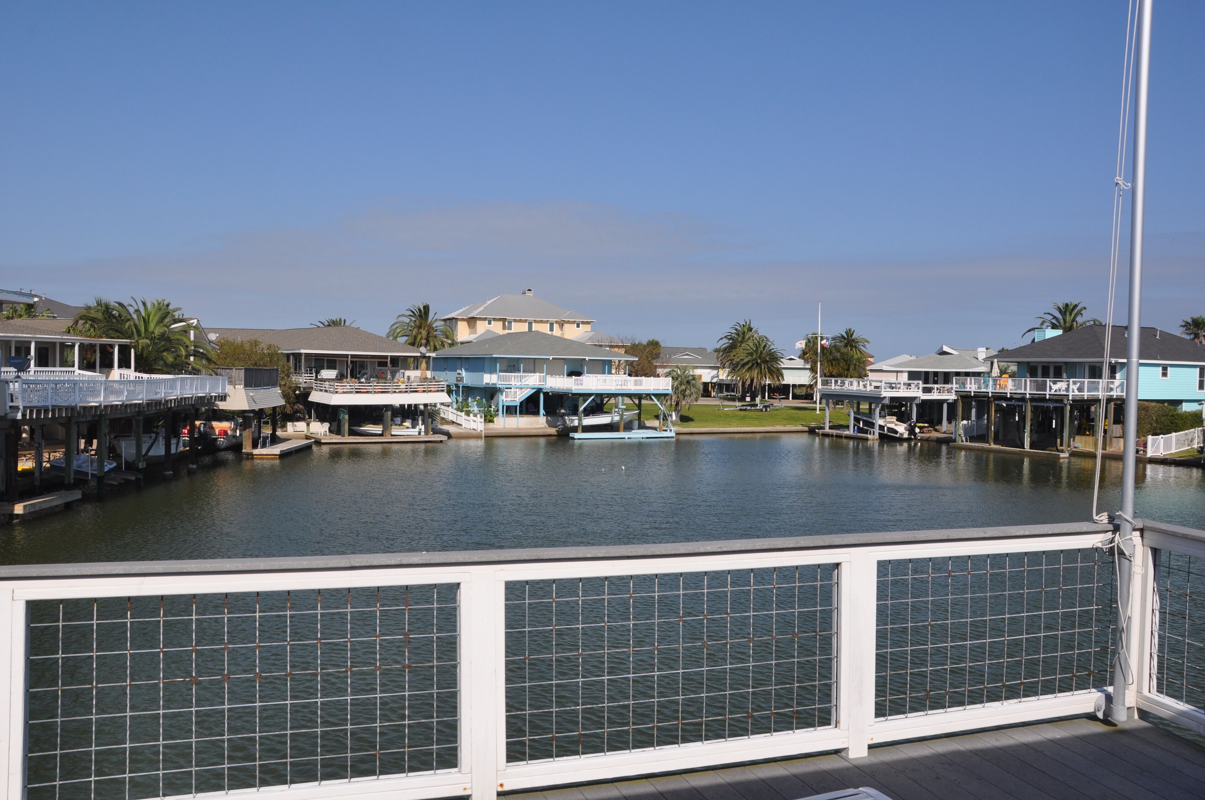 A waterfront property with a dock, a boat, and a building with a blue roof.