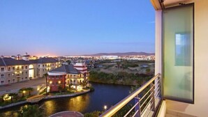 A view from a balcony overlooking a river with buildings and a bridge. - Knightsbridge 407 (Cape Town)