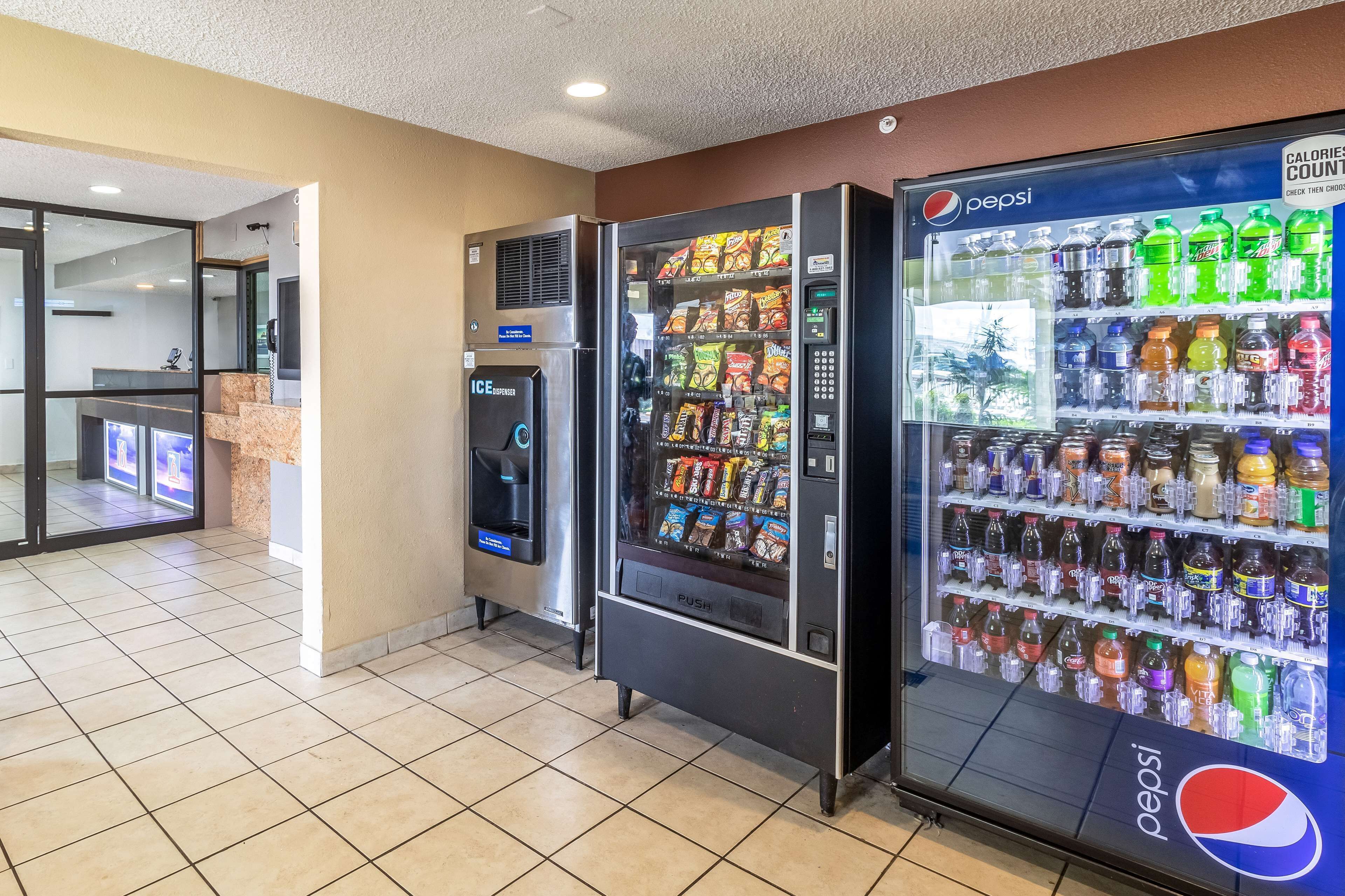 A vending area with a Pepsi refrigerator and a freezer, and a separate vending machine with snacks and drinks.