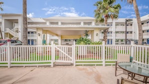 A hotel with a covered entrance, multiple balconies, and a gated driveway. - Studio 6 Corpus Christi, TX - North (Corpus Christi)