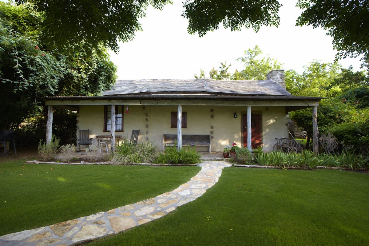A single-story house with a stone pathway leading to the front door.