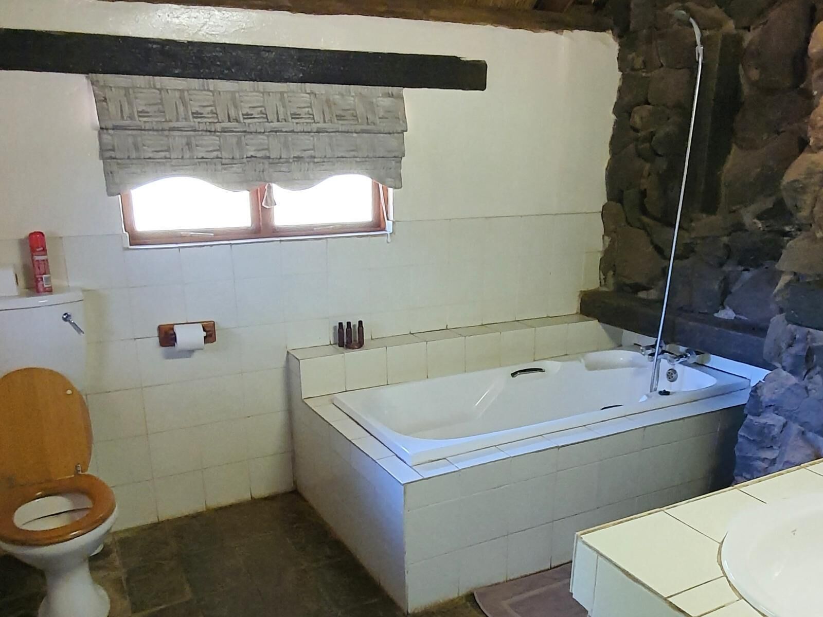 A bathroom with a bathtub, toilet, and sink.