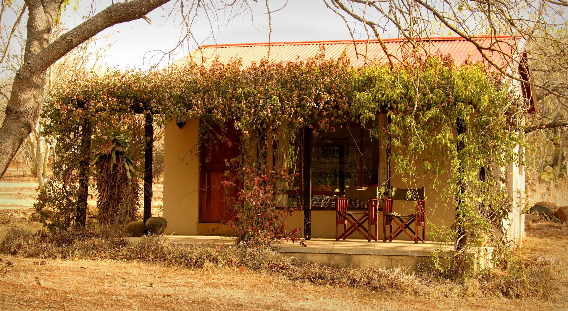 A building with a red roof and a covered porch.