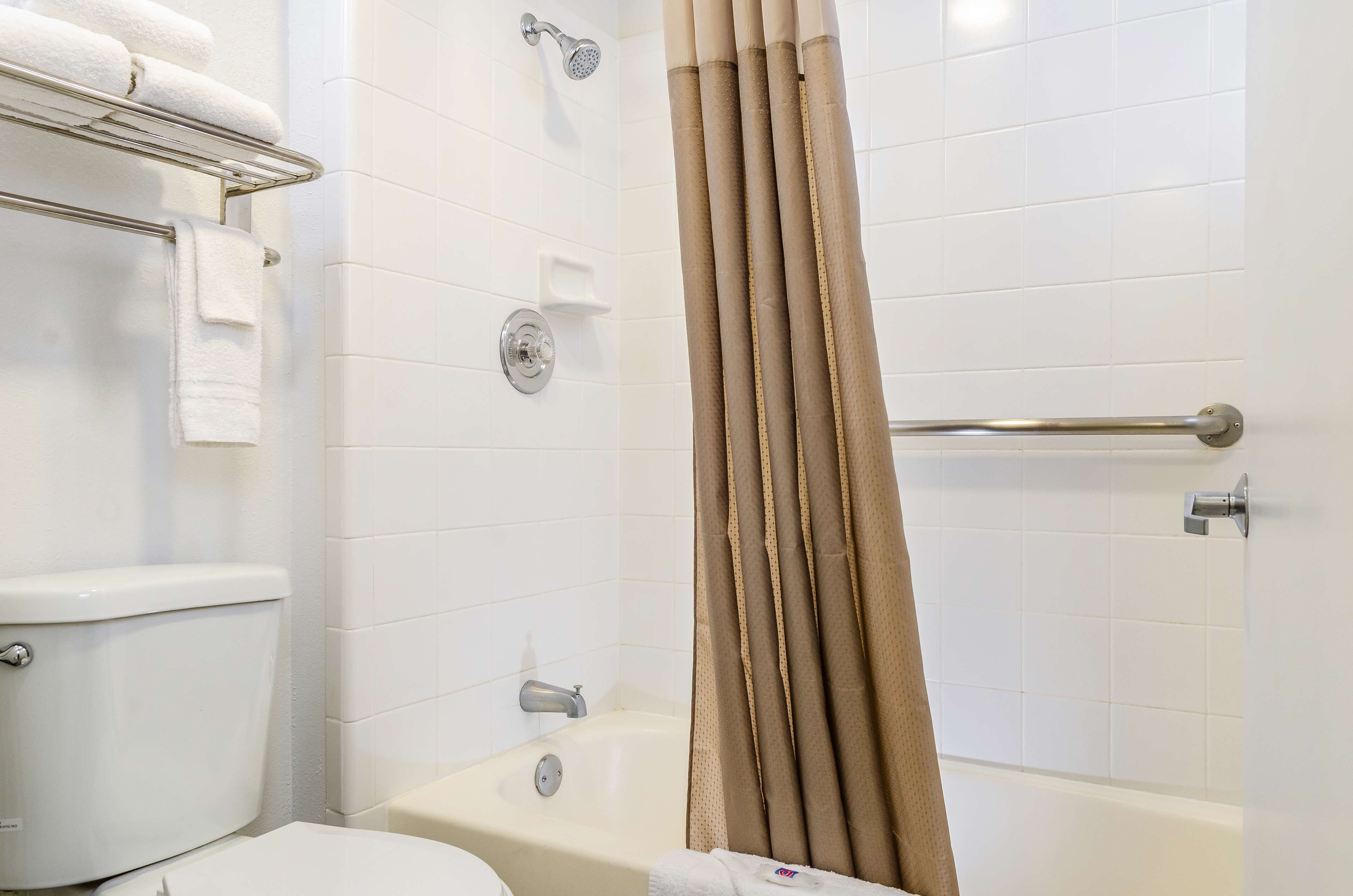 A bathroom with a toilet, a shower, and a bathtub.