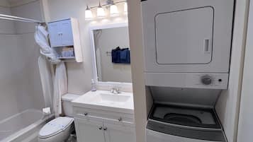 Bathtub, hair dryer, towels, soap