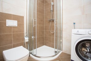 Bañera con ducha, secador de pelo, toallas, papel higiénico