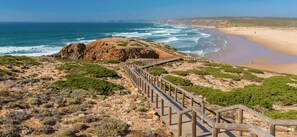 A coastal landscape with a wooden boardwalk leading to a beach. - "Casa da Charca" - SW Alentejano (Odemira)
