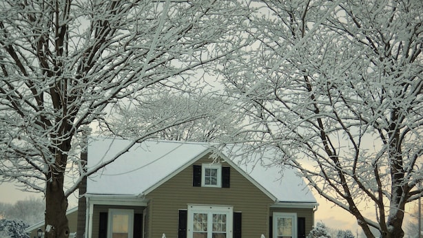A two-story house with a gabled roof, surrounded by snow-covered trees. - Cozy country bungalow within the Amish Community (Leacock-Leola-Bareville)