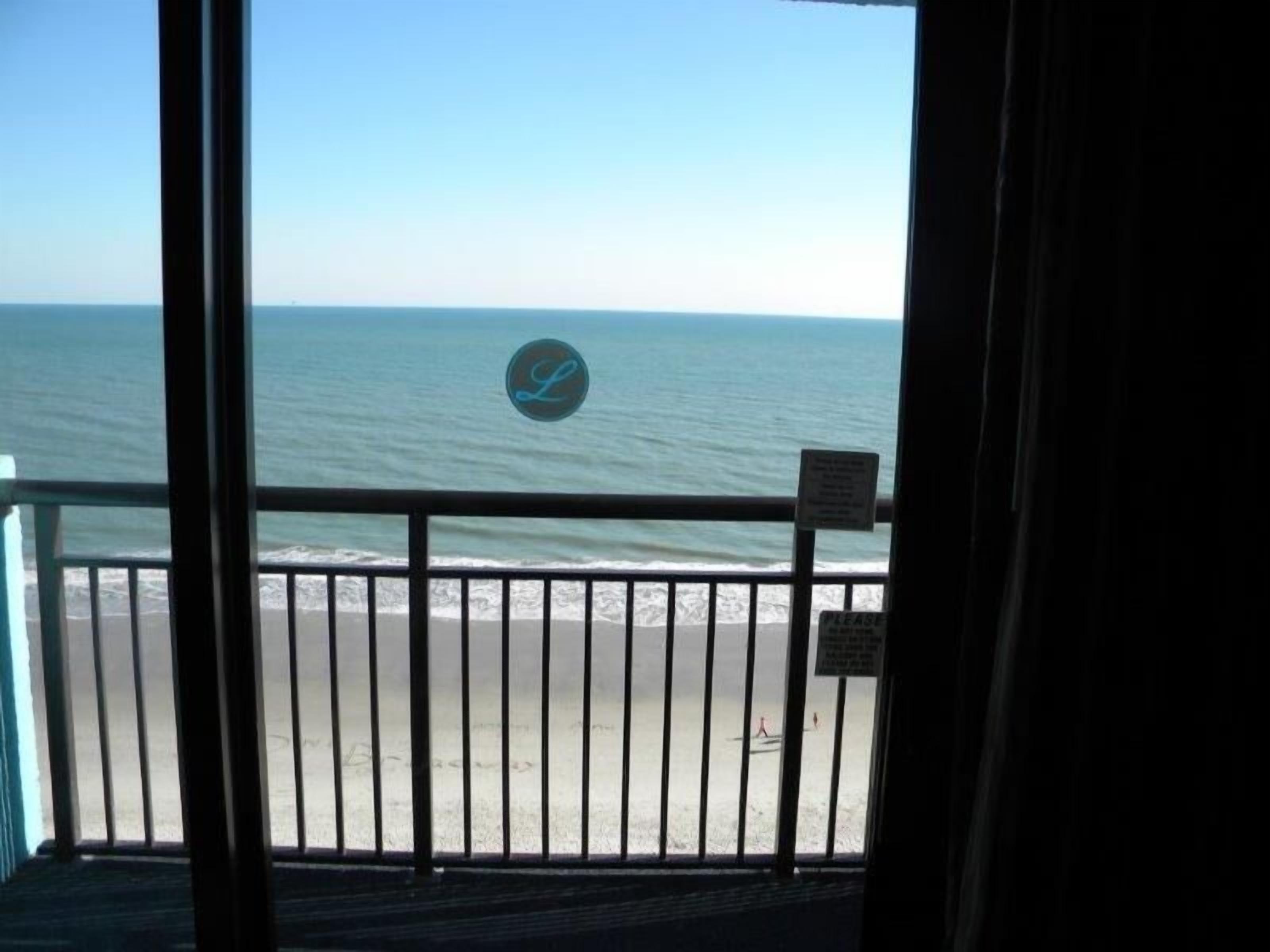 A balcony with a view of the ocean.