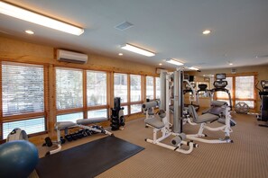 Work out in style with a fully equipped gym featuring a bench press, leg press, and rowing machine.