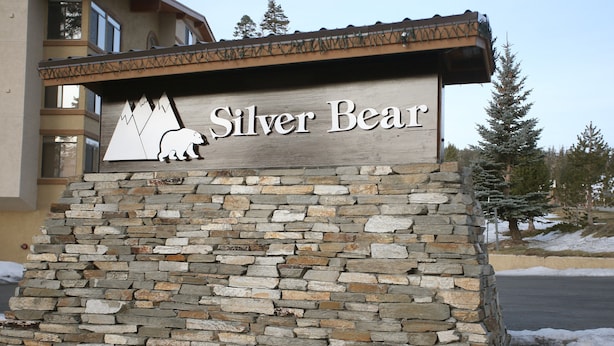 A sign for "Silver Bear" with a bear graphic and mountain design.