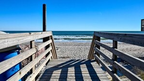 A wooden boardwalk leading to a beach with a clear blue sky. - This' L Do - Oceanfront - Upcycled Vintage Beach Cottage (North Topsail Beach)