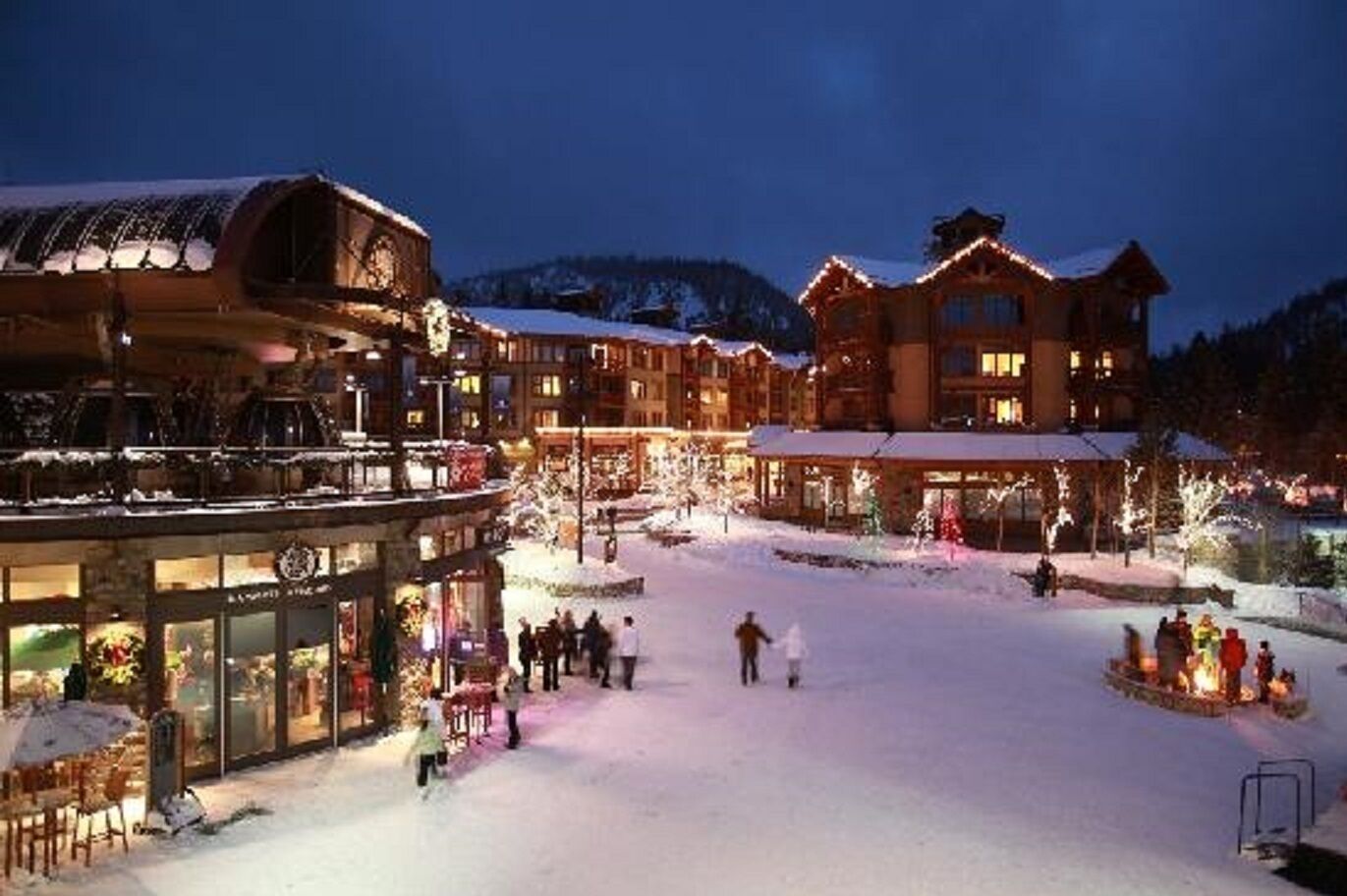 A snow-covered outdoor area with buildings and a covered walkway.