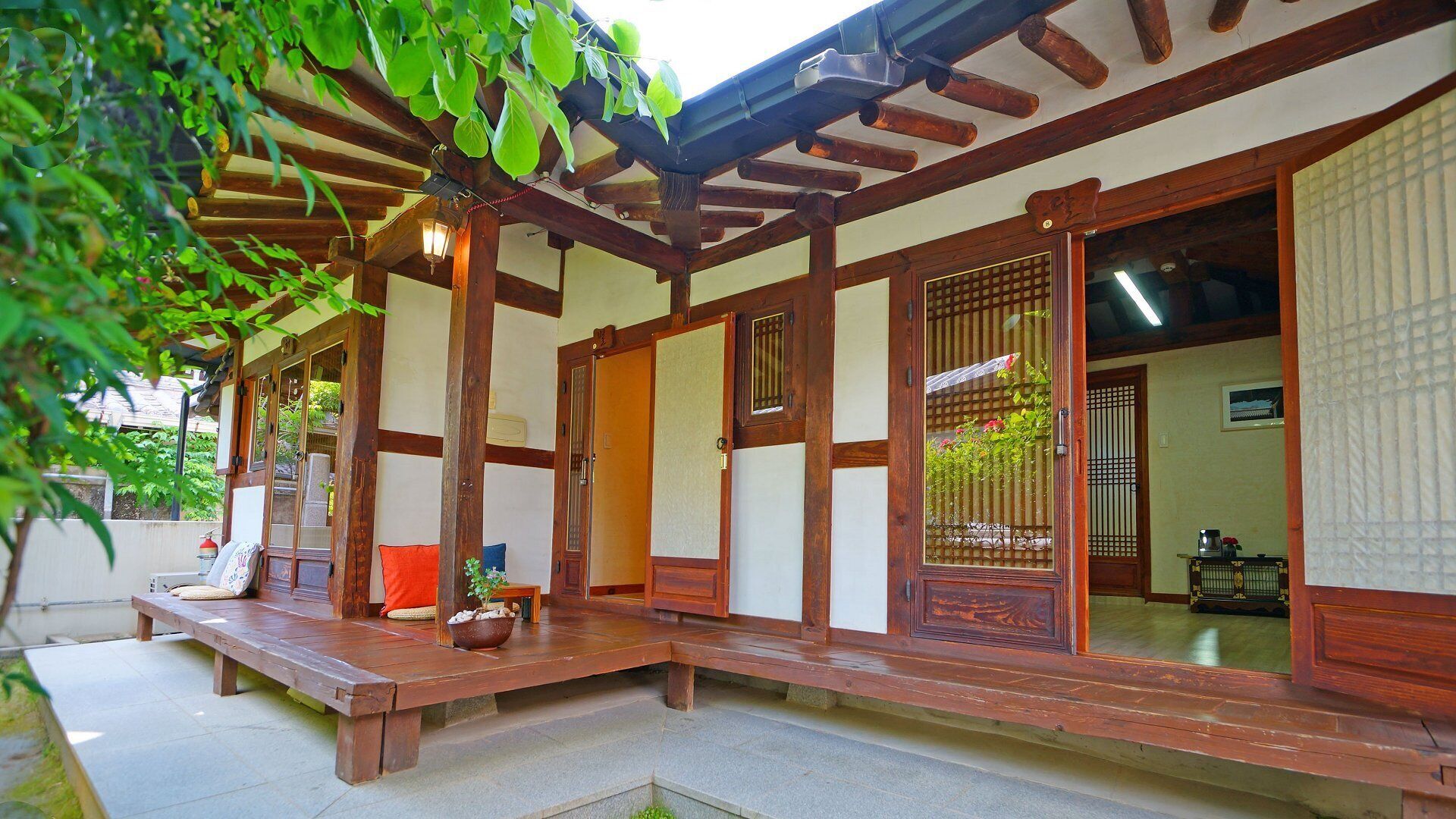 A traditional Japanese-style building with wooden beams, tatami mats, and sliding doors.
