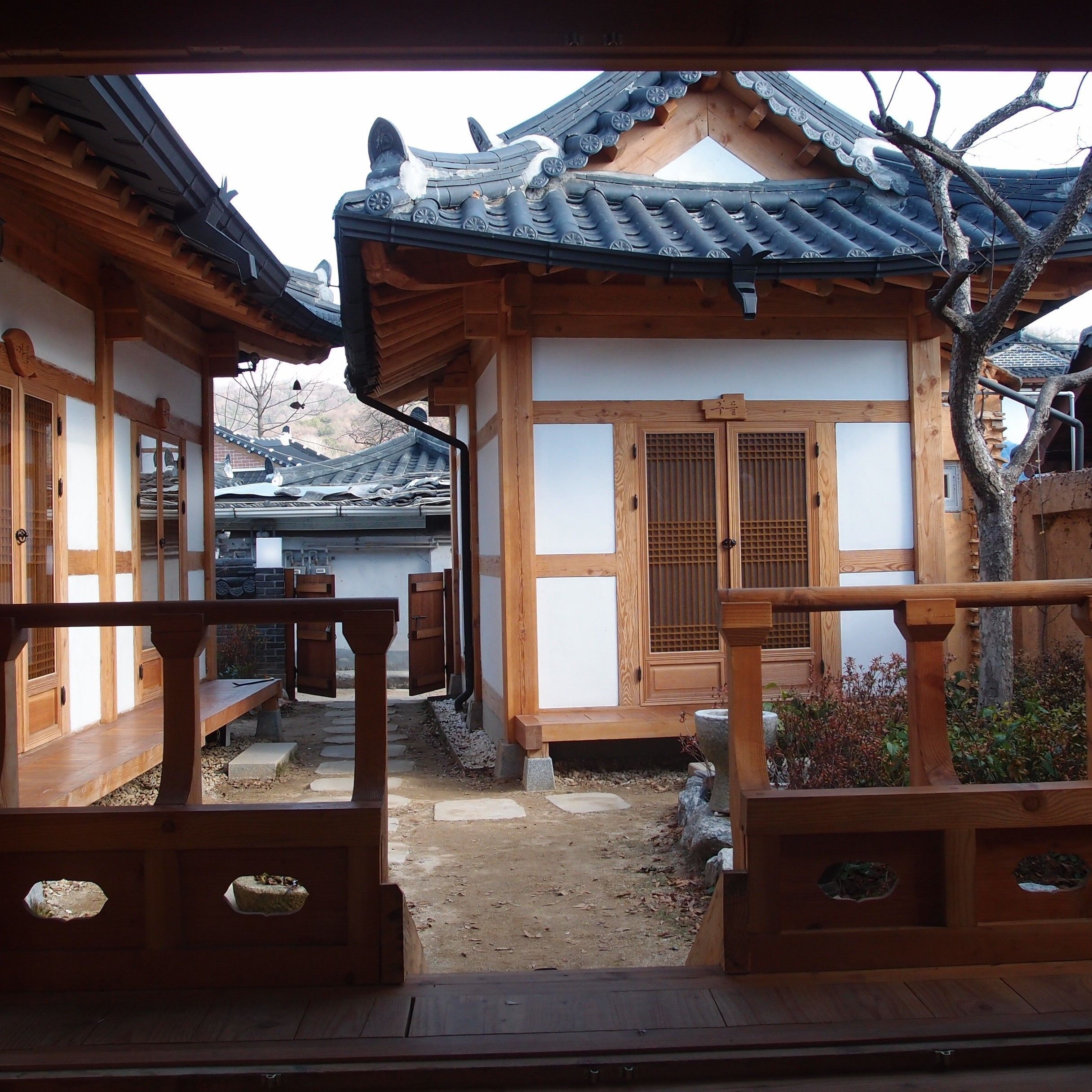 A traditional Japanese building with wooden architecture, including a tiled roof and sliding doors.