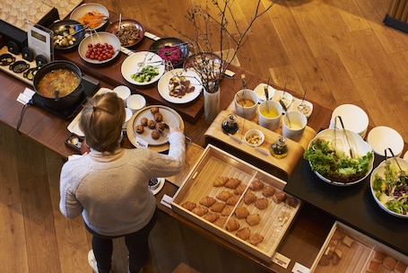 A buffet with various dishes and a display of croissants.. Nohga Hotel Ueno Tokyo