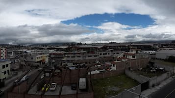 Vista de un paisaje urbano con varios edificios, calles y un estacionamiento.