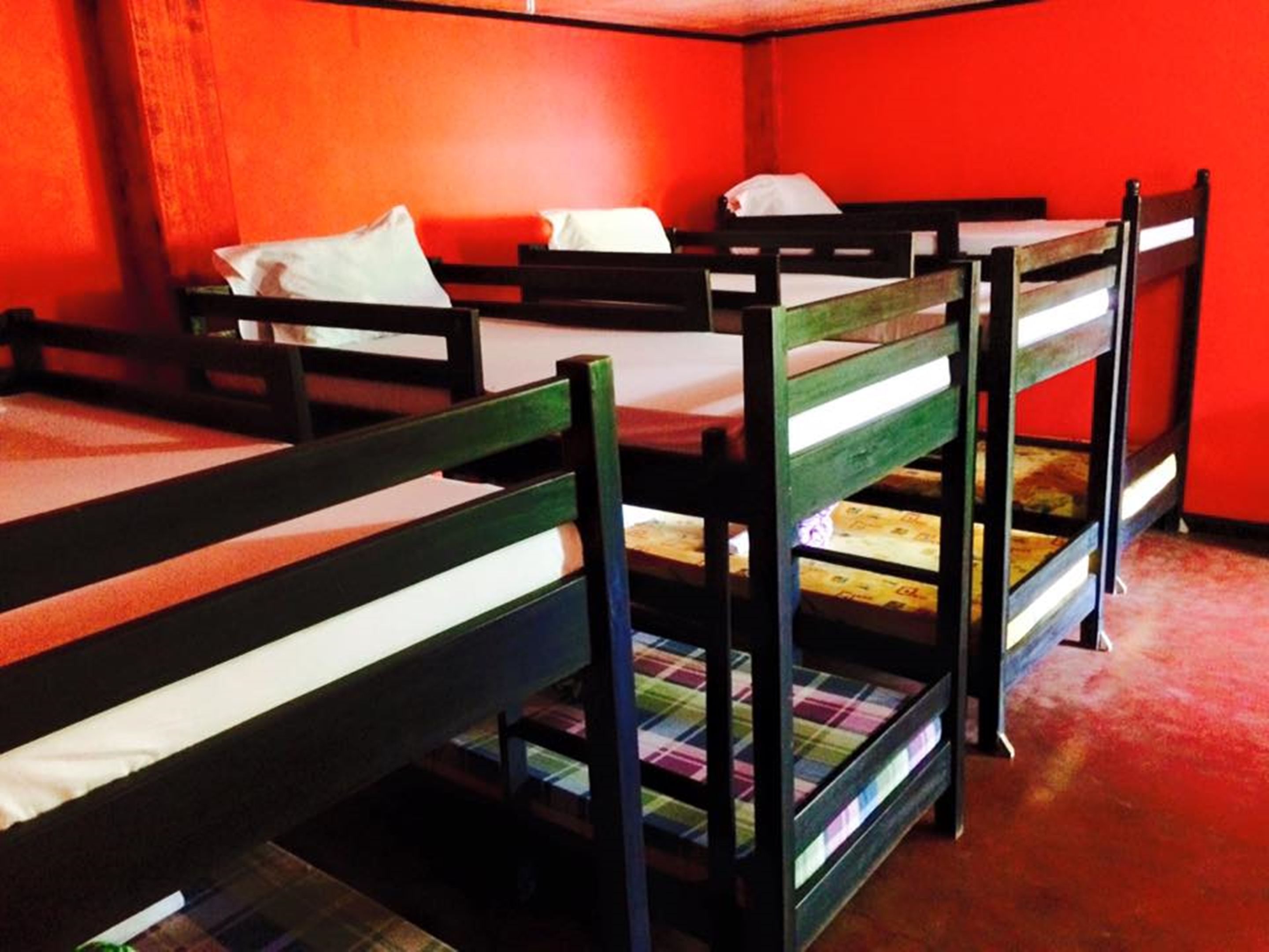 Bunk beds with white pillows and a plaid blanket.