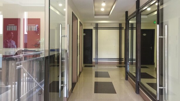 A modern hallway with glass doors, metal railings, and a tiled floor. - 5F18 Your home baguio (Baguio)