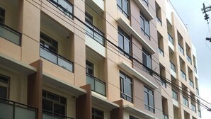 A multi-story building with balconies, a sign indicating a right of way, and a potted plant in the foreground. - 5F18 Your home baguio (Baguio)