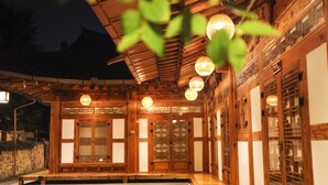 A traditional wooden building with a covered entrance and multiple lanterns. - Samlockhon (Jeonju)