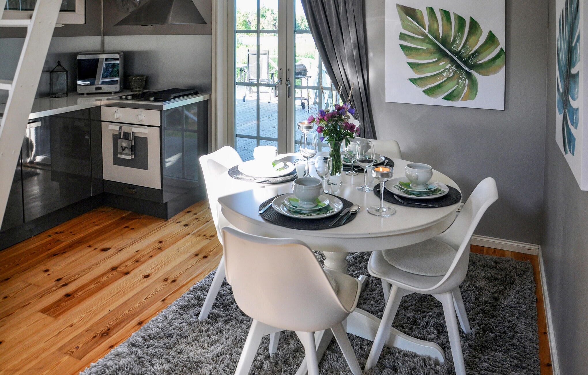 A modern kitchen with a dining area.