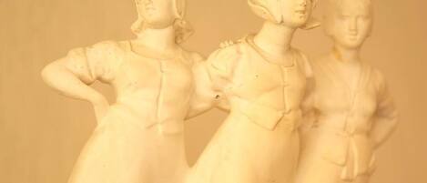 A white sculpture of three figures.
