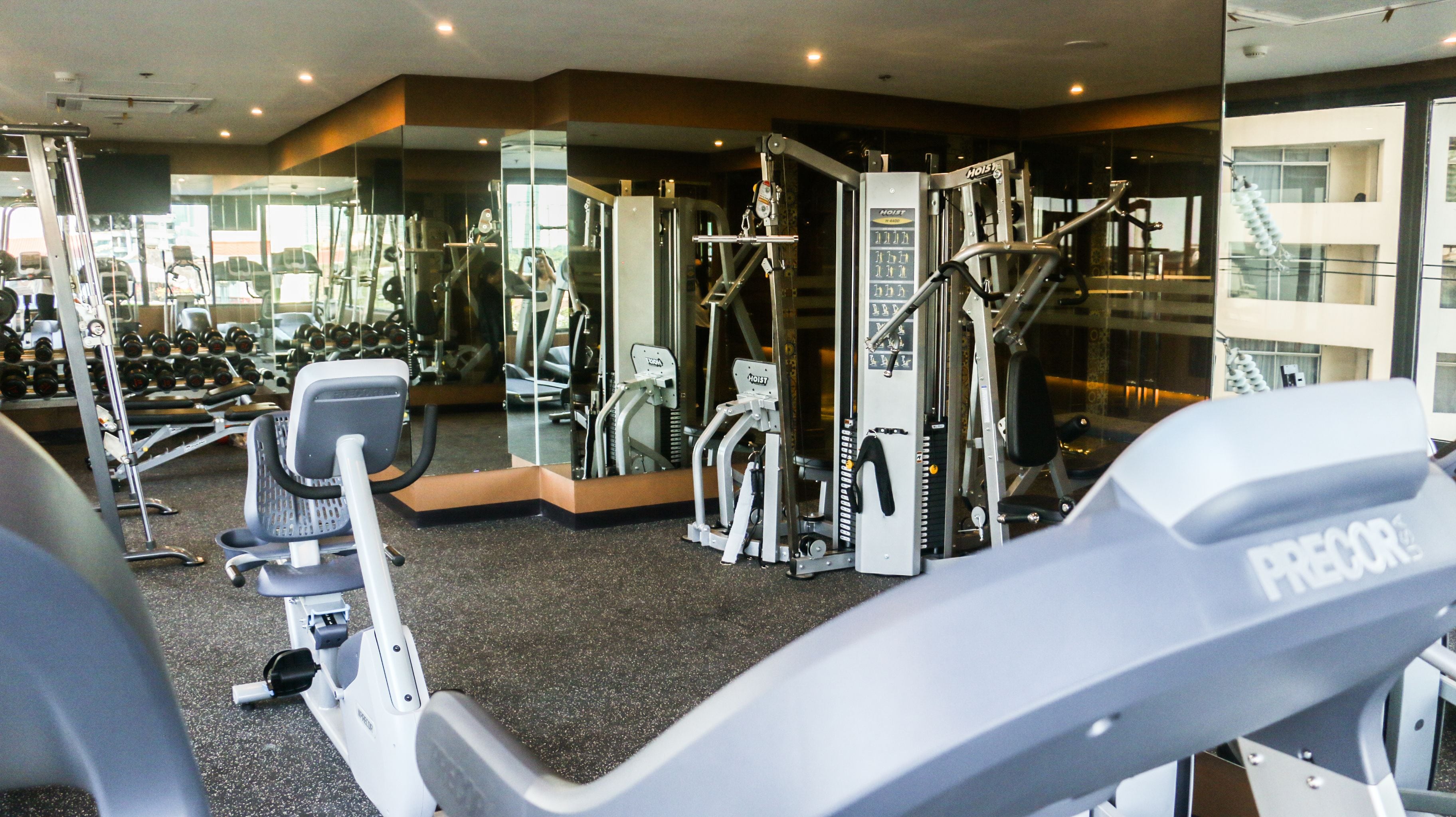 A gym with various exercise equipment, including treadmills and weight machines.