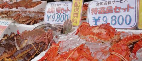 A seafood display with various types of seafood, including crabs, arranged on ice.