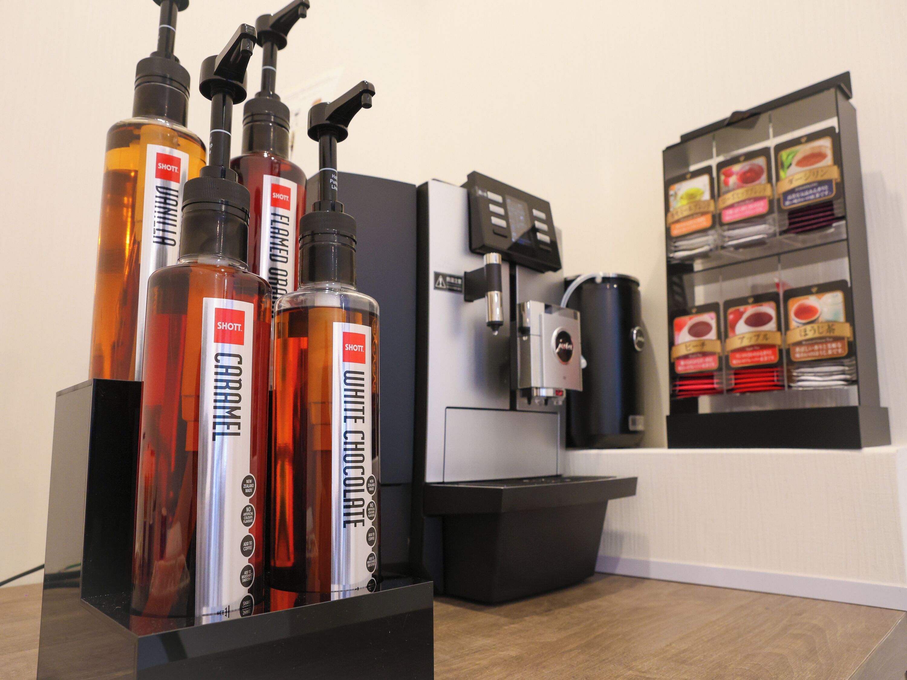 A coffee station with a coffee machine and a display of coffee pods.
