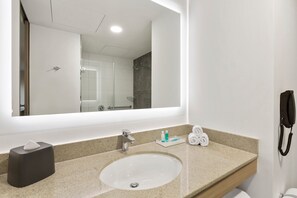 A bathroom with a large mirror, a sink, a towel rack, and a telephone. - Holiday Inn Express Lima San Isidro by IHG (Lima)