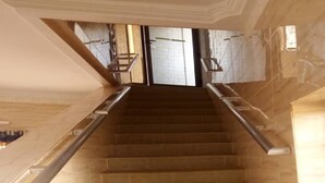 A staircase with a handrail, leading to an upper floor. - Villa des Hôtes II (Yamoussoukro)