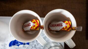 Two white mugs with a caramel-colored biscuit inside.
