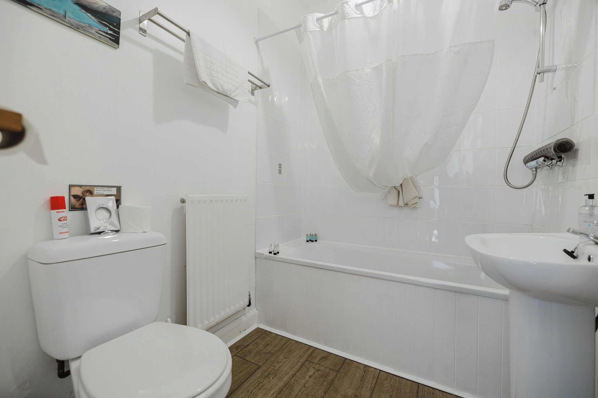 A bathroom with a toilet, a bathtub, and a sink.